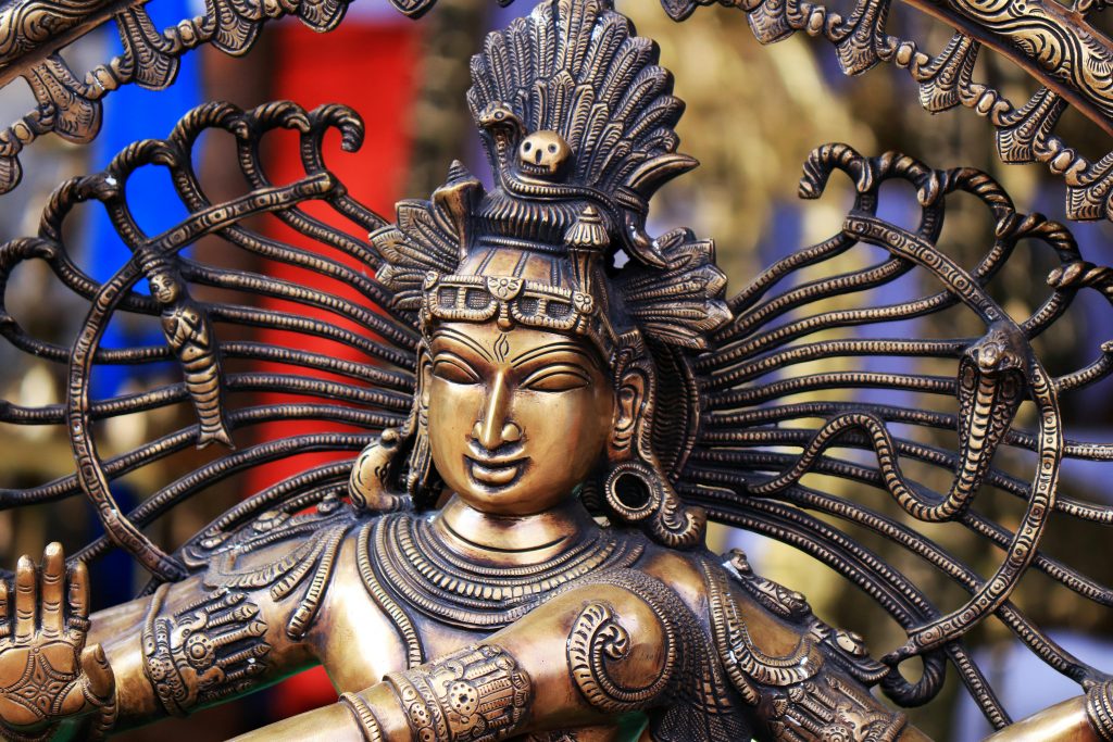 Detailed close-up of a brass Nataraja statue showcasing intricate artistry and cultural symbolism.