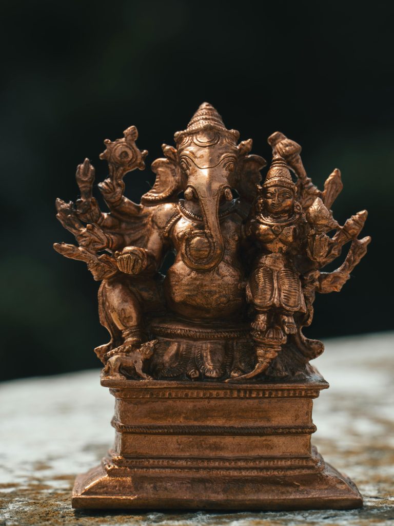 Detailed brass statue of Ganesha, showcasing intricate Hindu craftsmanship.
